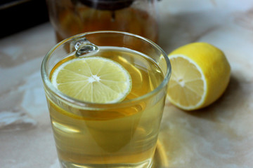 Green tea with lemon in the glass cup