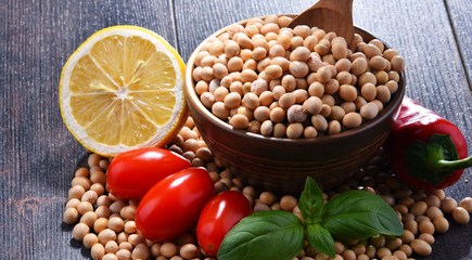 Composition with bowl of soya beans on wooden table