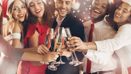 Diverse friends clinking with champagne glasses on New Year's Eve
