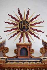 IHS sign on the main altar in the chapel of St. Wolfgang in Vukovoj, Croatia