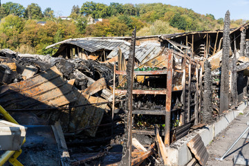 Burned damaged ruins of destroyed supermarket arson investigation insurance