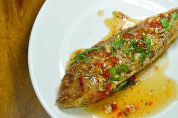 crispy fried sharp tooth snapper dressing with sweet chili sauce on plate