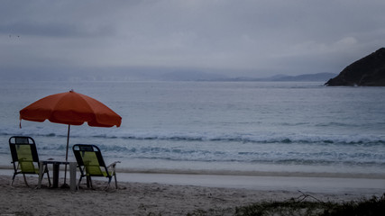 Chairs and umbrella at the edge of the beach