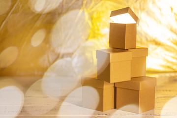Small cardboard gift boxes with bokeh effect as concept of christmas sale.
