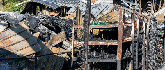 Burned damaged ruins of destroyed supermarket arson investigation insurance