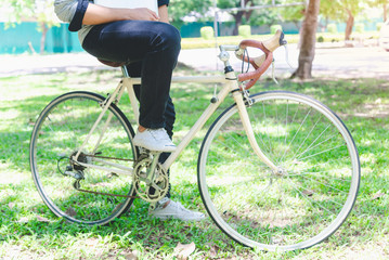 Naklejka premium Handsome young man are sitting bicycle with a fun and exchange of knowledge learning in the university educational concepts and technology.