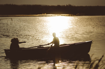 Fototapeta na wymiar The boat at sunset on the lake