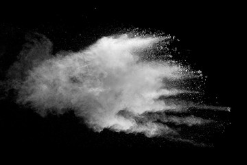 Explosion of white dust on black background.