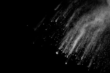 Explosion of white dust on black background.