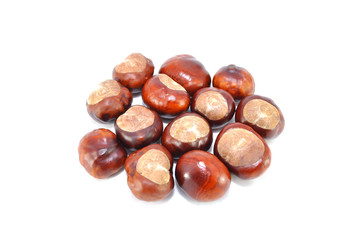 Ripe chestnuts on white background close-up