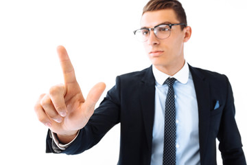 businessman wearing glasses and suit, touching an imaginary screen, presses an imaginary button on white background