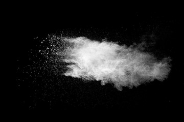 Naklejka premium Explosion of white dust on black background.