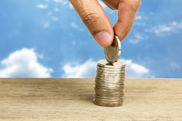Hand picking up coins