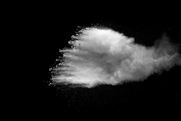 Obraz na płótnie Canvas Explosion of white dust on black background.