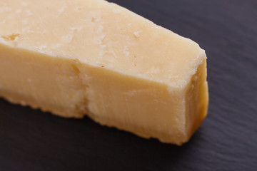 Parmesan slice on a stone slate plate