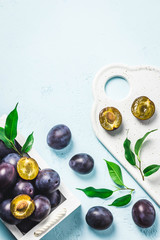 Ripe plums in a box. Top view, space for text.