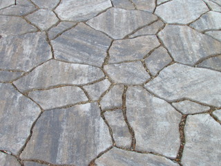 Texture gray natural stone garden pavement, decorative mosaic of flat stones