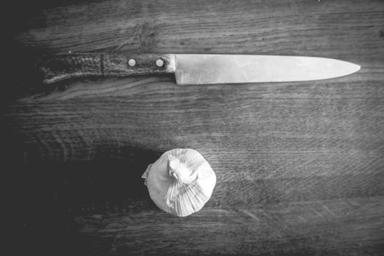 Top view of knife and garlic head