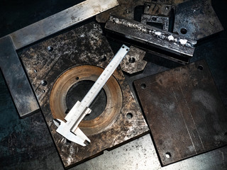 top view of calipers on metal workbench