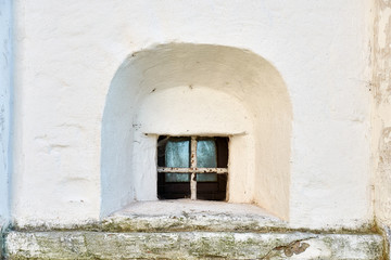 Small window in the tower wall of an ancient building in the Joseph-Volotsky russian monastery