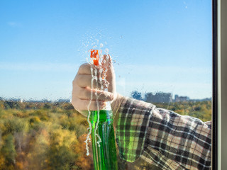 Naklejka na ściany i meble spraying the washing liquid on glass