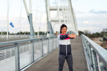 Fitness woman is stretching her hands