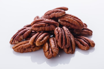 delicious pecan nuts on a white acrylic background