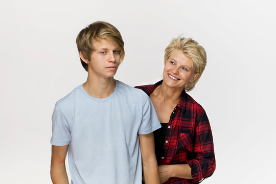 Family portrait. Smiling mother and son wearing casual clothing