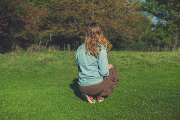 Fototapeta premium Young woman relaxing in a meadow