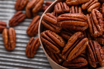 delicious pecan nuts on a rustic wooden background