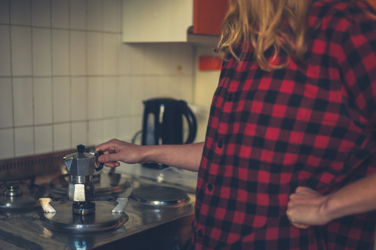Woman preparing coffee witha moka pot