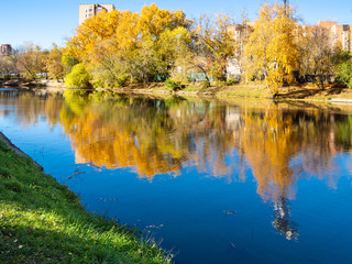 river in urban park in sunny autumn day