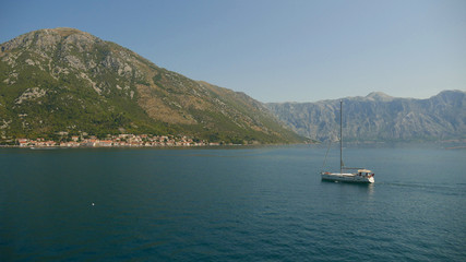 Picturesque view of the waters of the Bay of Kotor and the high mountains rising in the background.