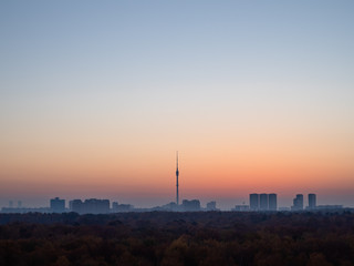blue dawn sky over city and urban park