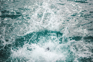 Splash as person jumps into the turquoise water of the Caribbean Sea