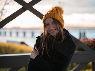 Sunset portrait of beautiful girl in Yellow Hat. Winded, Blur background.