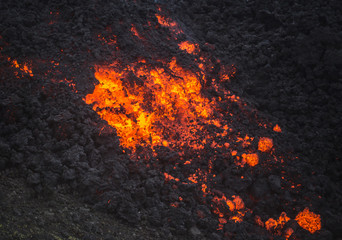 Red hot volcanic rock rolls down the side of the active Pacaya volcano, Guatemala