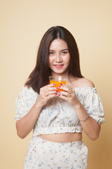 Young Asian woman drink orange juice.