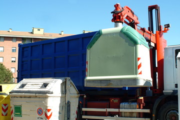 Mechanized lifting of glass disposal container.
