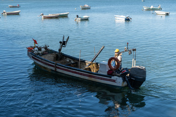 Obraz premium fisherman on his boat during a working day black and white