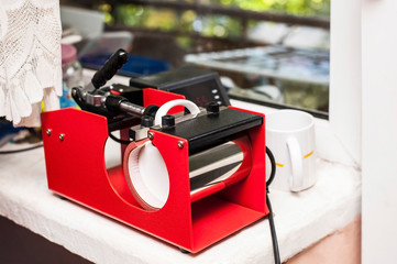 Naklejka premium The thermotransfer press for cups, mugs is intended for transfer of the image, a logo, the photo, an inscription on mugs, cups