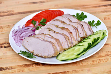 Sliced ham for the holiday. Baked ham with vegetables.