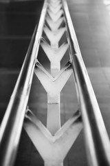 a metal handrail at stairs in the urban - close up - monochrome