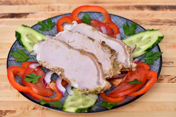 Sliced ham for the holiday. Baked ham with vegetables.