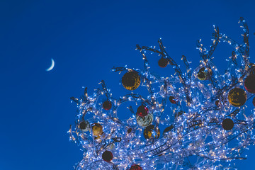 christmas ball lit by leds on night background with moon