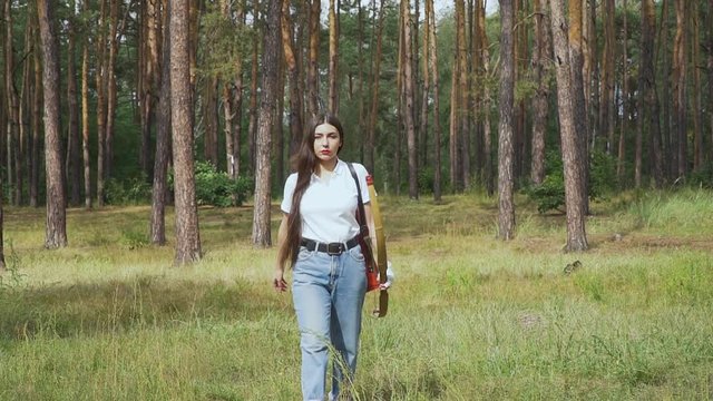 Female archer walking in the forest