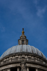 London, UK. Close up of the dome of St Paul's Cathedral against bright blue sky.