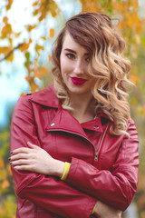 A girl in a leather jacket, autumn park, an autumn photo session of a girl in a leather jacket