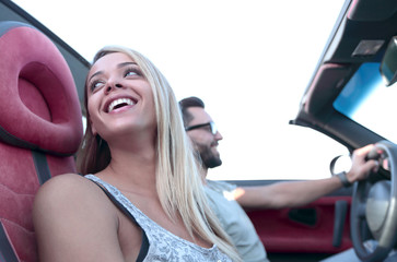 young young young woman and her boyfriend sitting in convertible