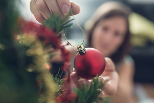 Young Woman Decorating Holiday Tree